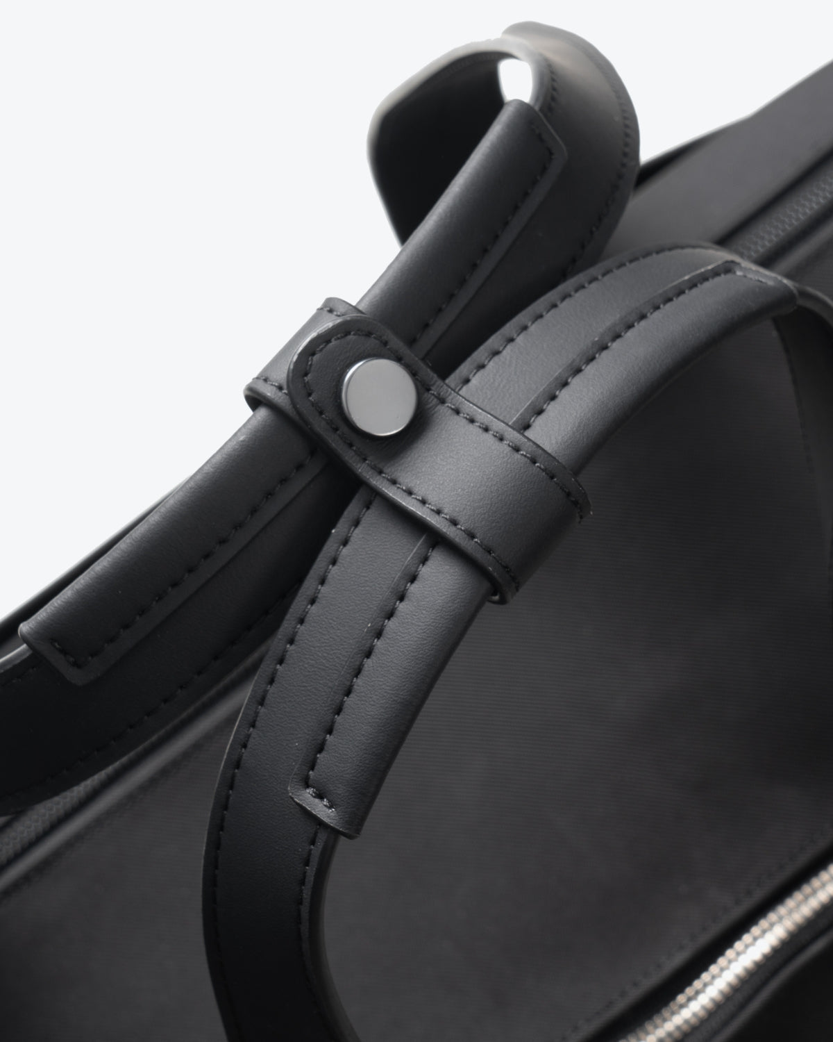 Close-up of comfortable padded top handle with snap wrap on LEVEL8 CITYGO Bag